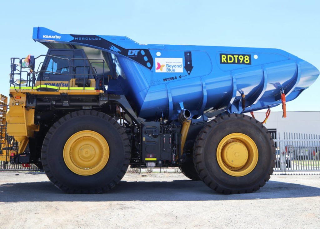 Large mining truck with blue traybed with beyond blue logos attached